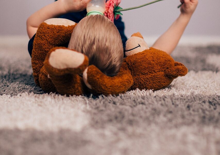 Child laying on carpet