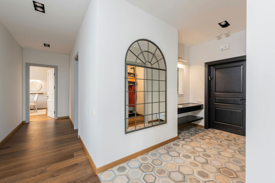 Hallway with tile and wood floors